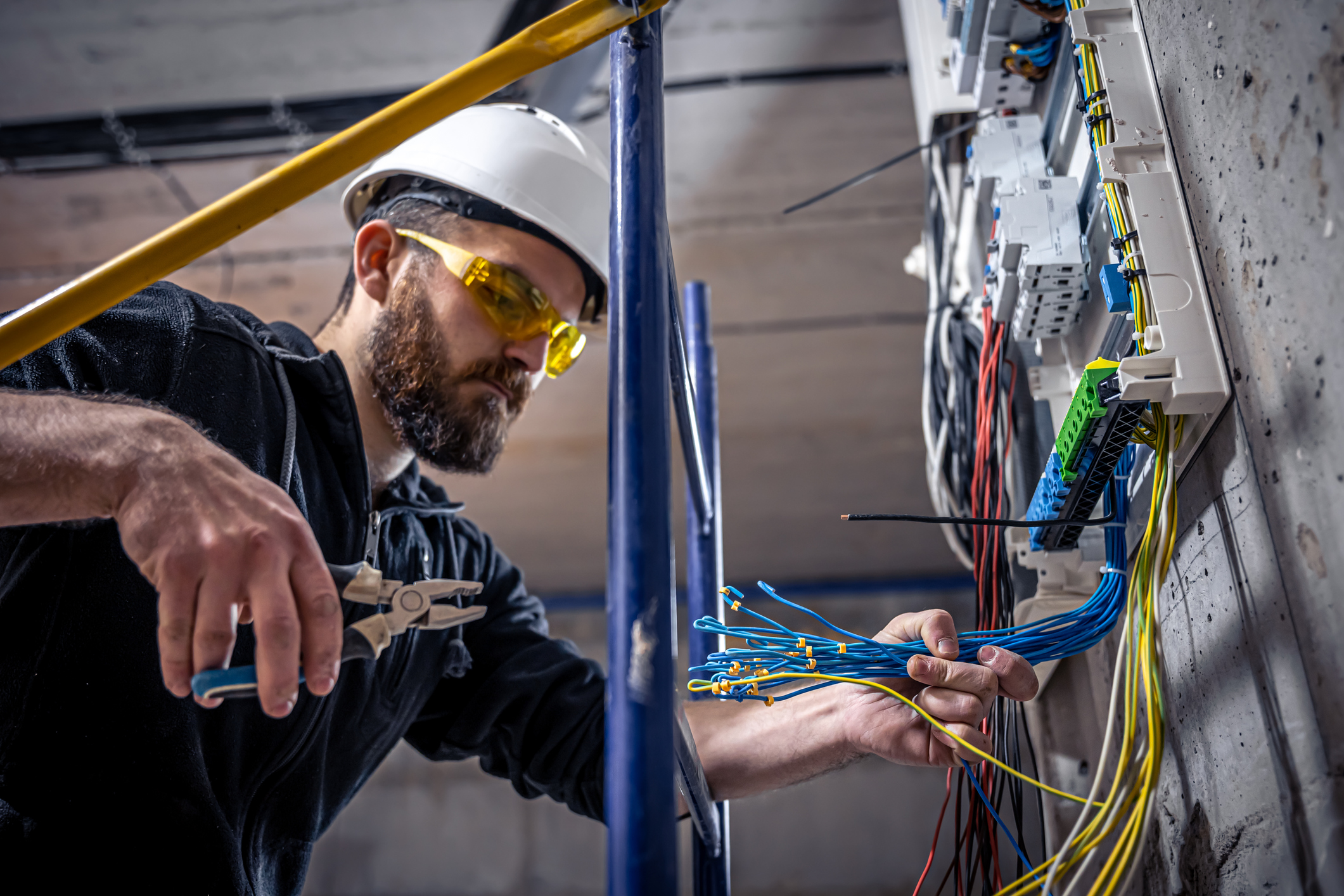 Electrician troublshooting a panel